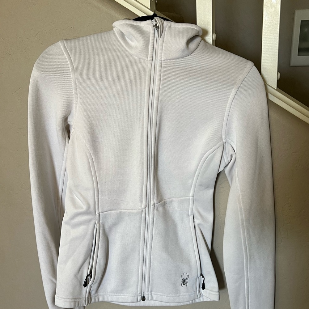 Women’s White Spyder core zip up jacket.
